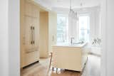 The portal to the pantry is flanked by tall storage cabinets and a built-in Fisher &amp; Paykel Professional Series refrigerator and freezer.