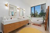 This custom freestanding tub in the penthouse bathroom offers city views and is large enough for two.