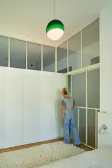 Graced with another Marset Dipping Light pendant, the bedroom stars a large, space-saving closet dreamed up by Sarolta.