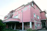 Sarolta's apartment is housed inside a historic Budapest villa flaunting a distinctive rose-colored facade.