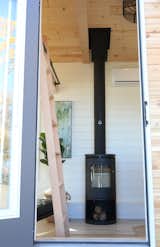 The Morso wood burning stove is centered in front of the door and can be seen through the glass panel.  It is a features from both in and outside the home.