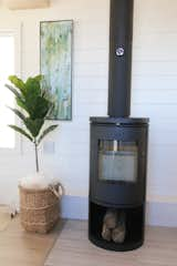 Living Room, Laminate Floor, Recessed Lighting, and Wood Burning Fireplace The focal point in this home is certainly the Morso wood burning stove complete with wood storage area. We love this fireplace because it is rated for mobile homes and needs very little clearance for installation.   Photo 4 of 19 in Innisfree Anarres by Jennifer McCarthy