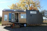 Exterior, Metal Siding Material, A-Frame RoofLine, Wood Siding Material, Metal Roof Material, and Tiny Home Building Type Natural cedar and steel siding are used to create an appealing and modern exterior that will blend with it's surrounding environment.   Solar panels on the roof capture renewable energy to the battery bank located in the front of the tiny home.  The passive solar heat panel is located on the side of the home and provides back-up heat for the home owners during the day.  Photo 10 of 19 in Innisfree Anarres by Jennifer McCarthy