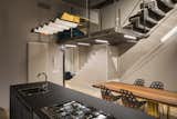 Kitchen, Ceiling Lighting, Dishwasher, Light Hardwood Floor, Cooktops, Pendant Lighting, Refrigerator, Metal Cabinet, Track Lighting, and Microwave Kitchen, ZAG lamp and BAU table  Photo 20 of 35 in Blue and concrete apartment by DVDV Studio Architects
