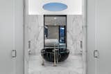 Bath Room, Marble Wall, Freestanding Tub, One Piece Toilet, Ceiling Lighting, Limestone Floor, Marble Counter, and Enclosed Shower  Photo 3 of 14 in Cayambe by Punch Architecture