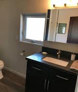 Bath Room, Granite Counter, Light Hardwood Floor, Undermount Sink, Wall Lighting, Enclosed Shower, Vinyl Floor, Recessed Lighting, and Two Piece Toilet Upstairs Bathroom  Photo 20 of 38 in The Chateau, a Rustic Modern retreat by Stavros Georgiou