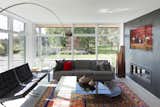 Living Room, End Tables, Concrete Floor, Gas Burning Fireplace, Coffee Tables, Chair, Ceiling Lighting, Ribbon Fireplace, and Sofa  Photo 6 of 10 in Lakeview in the Beaches by Sustain Design Architects Inc.