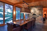Dining Room, Chair, Wood Burning Fireplace, Table, and Pendant Lighting  Photo 5 of 20 in Kasshabog Lake Cottage by Sustain Design Architects Inc.