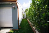 Artificial grass with an 8" drainage basin ensures that the walkway to the entrance stays dry even during typical torrential rains we get in south Florida. 