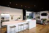 Contemporary family kitchen & living area with striking black feature ceiling.