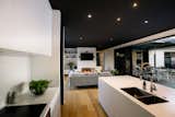 Contemporary family kitchen & living area with striking black feature ceiling.
