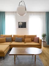 Living Room, Sofa, Coffee Tables, Light Hardwood Floor, and Pendant Lighting  Photo 2 of 43 in Chunky Finishes Combine With Curves in This Easter-Egg Colored Apartment by MUZA