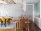Dining Room, Chair, Track Lighting, Storage, Light Hardwood Floor, Stools, Bar, Table, Pendant Lighting, and Accent Lighting  Photo 17 of 43 in Chunky Finishes Combine With Curves in This Easter-Egg Colored Apartment by MUZA