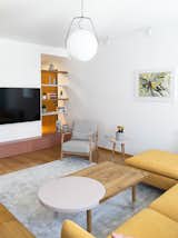 Living Room, Coffee Tables, Track Lighting, Pendant Lighting, Sofa, End Tables, and Light Hardwood Floor  Photo 3 of 43 in Chunky Finishes Combine With Curves in This Easter-Egg Colored Apartment by MUZA