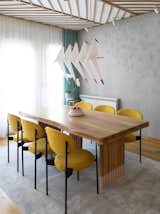 Dining Room, Track Lighting, Light Hardwood Floor, Pendant Lighting, Chair, and Table  Photo 9 of 43 in Chunky Finishes Combine With Curves in This Easter-Egg Colored Apartment by MUZA