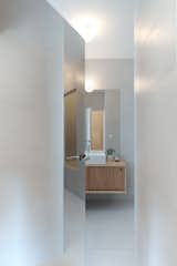 The mirrored door opens on the bathroom