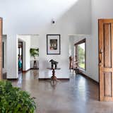 A handsome Kerala teak door adorns the entrance; the famous trunkless elephant sitting beyond the landscape is an antique. The owner purchased the door and artifacts from an old manor house near Mattancheri. The benches were custom-made by Humming Tree’s carpenters. The tall floor stand mirror was a gift from a dear friend; the photo frames on the wall are from Mysore.