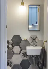 The powder room. - It takes so much effort to make it look 'effortless'. The tiler had to lay these tiles of 11 designs on the floor to get my approval.