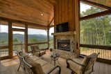 Living Room, Standard Layout Fireplace, Bench, End Tables, Coffee Tables, Chair, Ceiling Lighting, Medium Hardwood Floor, and Gas Burning Fireplace Screened in Exterior Porch  Photo 4 of 32 in 3 Peaks by Nic Seibert