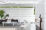 Dining Room, Two-Sided Fireplace, Ceiling Lighting, Chair, Table, and Concrete Floor white screen wall  Photos