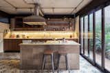 Kitchen, Wood Cabinet, Wall Mount Sink, Cooktops, Ceiling Lighting, and Ceramic Tile Floor  Photo 15 of 22 in Conde D'eu House by Estúdio Penha