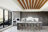 The kitchen features high-end kitchen appliances such as a fully built-in Gaggenau espresso machine and integrated wine cooler, both with touch electronic control systems. 