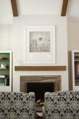 An oversized natural gas fireplace in the great room provides a cozy focal point, with details of wood grain tiling and a distressed white oak mantle for a modern touch. 