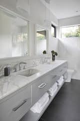 Guest Bathroom with floating vanity with marble counter and open storage