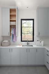 Laundry Room - concealed clothes hanging rod in upper cabinet