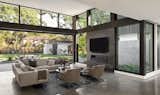 Living Room with two sided fireplace and large sliding pocket doors with ADU in background