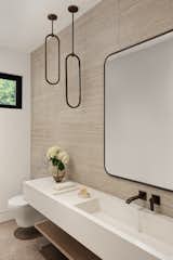 Powder Room with porcelain tile wall and integrated concrete sink and vanity