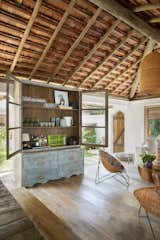 Living Room, Chair, and Medium Hardwood Floor This display cabinet made of demolition wood came from São Paulo especially to assume a key role the living room as a bar cabinet
  Photo 5 of 15 in Trancoso House by Lara Muniz