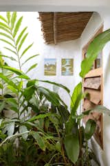 Outdoor Kept treasures: paintings that were already hanging on the walls of the house came to prominence due to the simple fact that the painting around them, now completely white, highlights their color. The authorship is unknown  Photo 11 of 15 in Trancoso House by Lara Muniz