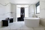 A shower and a bathtub provide a luxurious feel to the master bedroom bathroom.  Photo 4 of 19 in Eos Urban Villa by 3NK Engineers & Architects