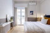 Bedroom, Bed, Light Hardwood Floor, Night Stands, Ceiling Lighting, and Wall Lighting Bedroom   Photo 7 of 16 in Small eclectic apartment in Koukaki, Athens by 3NK Engineers & Architects