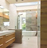 Bath Room, Undermount Sink, Ceiling Lighting, Quartzite Counter, Porcelain Tile Floor, Freestanding Tub, Ceramic Tile Wall, Recessed Lighting, Two Piece Toilet, and Open Shower Primary Suite Bath.  Private terrace is just steps away.  Photo 3 of 10 in Holman House by Shawn Bradbury