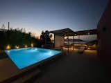 Outdoor, Shrubs, Landscape Lighting, Trees, Garden, Concrete Patio, Porch, Deck, Hardscapes, Side Yard, Concrete Pools, Tubs, Shower, Hanging Lighting, Walkways, Small Pools, Tubs, Shower, Slope, Concrete Fences, Wall, Small Patio, Porch, Deck, Stone Fences, Wall, and Tile Patio, Porch, Deck Pool Terrace - night  Photo 8 of 13 in The Float House by ss.mm design