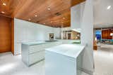 The premium kitchen, outfitted with opaque glass surfaces, is perfect for entertaining.