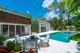 Outdoor, Large Patio, Porch, Deck, Stone Patio, Porch, Deck, Back Yard, Swimming Pools, Tubs, Shower, Planters Patio, Porch, Deck, Concrete Pools, Tubs, Shower, Flowers, and Trees  Photo 5 of 35 in The Banyan Beach House Asks a Breezy $3.6 Million by Premier Sotheby's International Realty