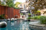 A sheltered zen-like courtyard, heated Gunite pool, Ipe privacy fence, outdoor shower and shade structure allow for seasonal living and entertaining.