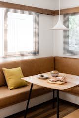A cozy breakfast nook at the front of the house gets a glimmer of soft morning light.