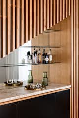 Happy hour has never looked so good. The home's wet bar receives stylish treatment with an asymmetrical facade and mirrored background.