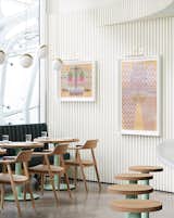 Colorful artwork adds some personality to the restaurant's textured, white walls.