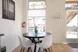 Dining Room, Shelves, Table, Concrete Floor, Lamps, Chair, Accent Lighting, and Ceiling Lighting  Photo 12 of 34 in Modern Baca Railyard apartment 104 by Solange + Andres