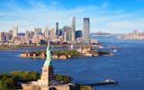 Floor-to-ceiling windows frame dramatic vistas of the Manhattan skyline, World Trade Center, New York Harbor and Statue of Liberty.