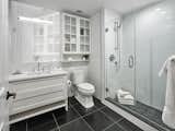 Lavish baths boast Kohler fixtures and white glass wall tiles. 