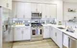 Kitchens boast crisp, white quartz countertops and modern stainless-steel appliances.