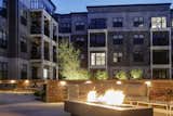 Outside, residents enjoy a courtyard with seating areas, outdoor dining, a firepit and grills.