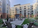 An expansive landscaped courtyard features dining areas, BBQ stations, lounge seating and firepits.