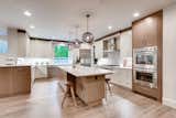 Spacious kitchen beautifully and thoughtfully designed. The kitchen features gourmet appliances, orbed glass-blown lights over the large island, and plenty of storage. 